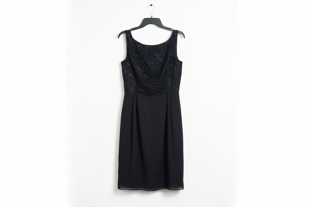 Black dress with lace detailing on a wooden surface