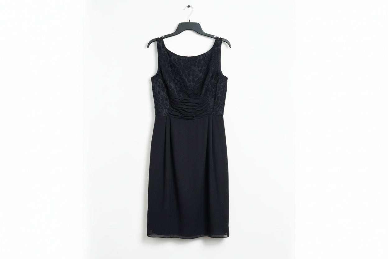 Black dress with lace detailing on a wooden surface