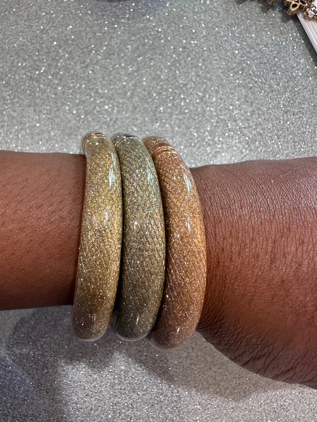 Three glitter bracelets
